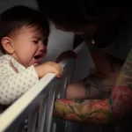 Mummy lulling baby to sleep 655734582 1256x838